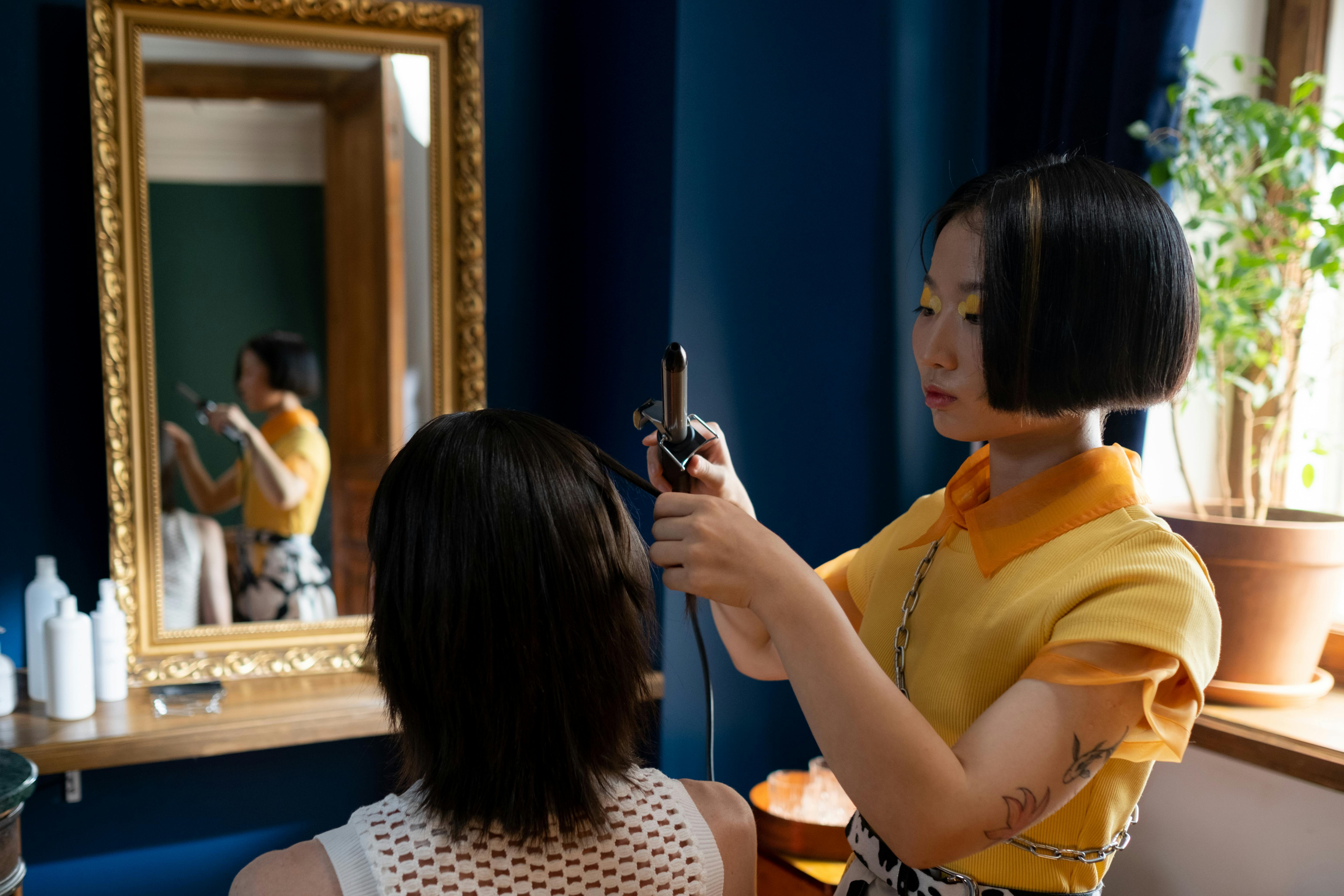 Professionelles Haarstyling mit Lockenstab im Salon Glamour